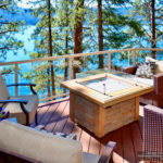 Glass railing with firepit on a lake